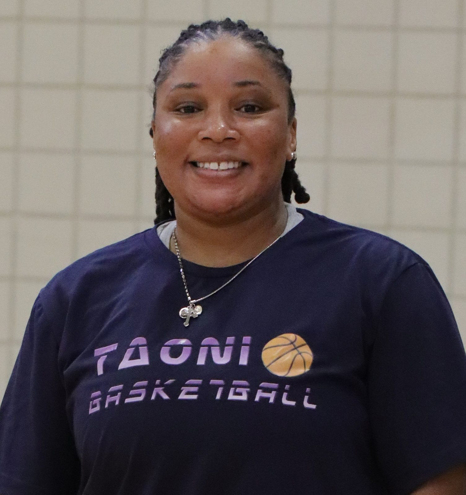 Coach Kiara Glenn in her TAONI Basketball shirt.