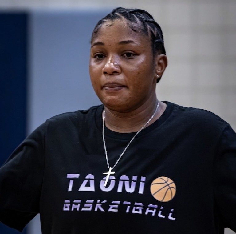 Coach Kiana Glenn in her TAONI Basketball shirt.