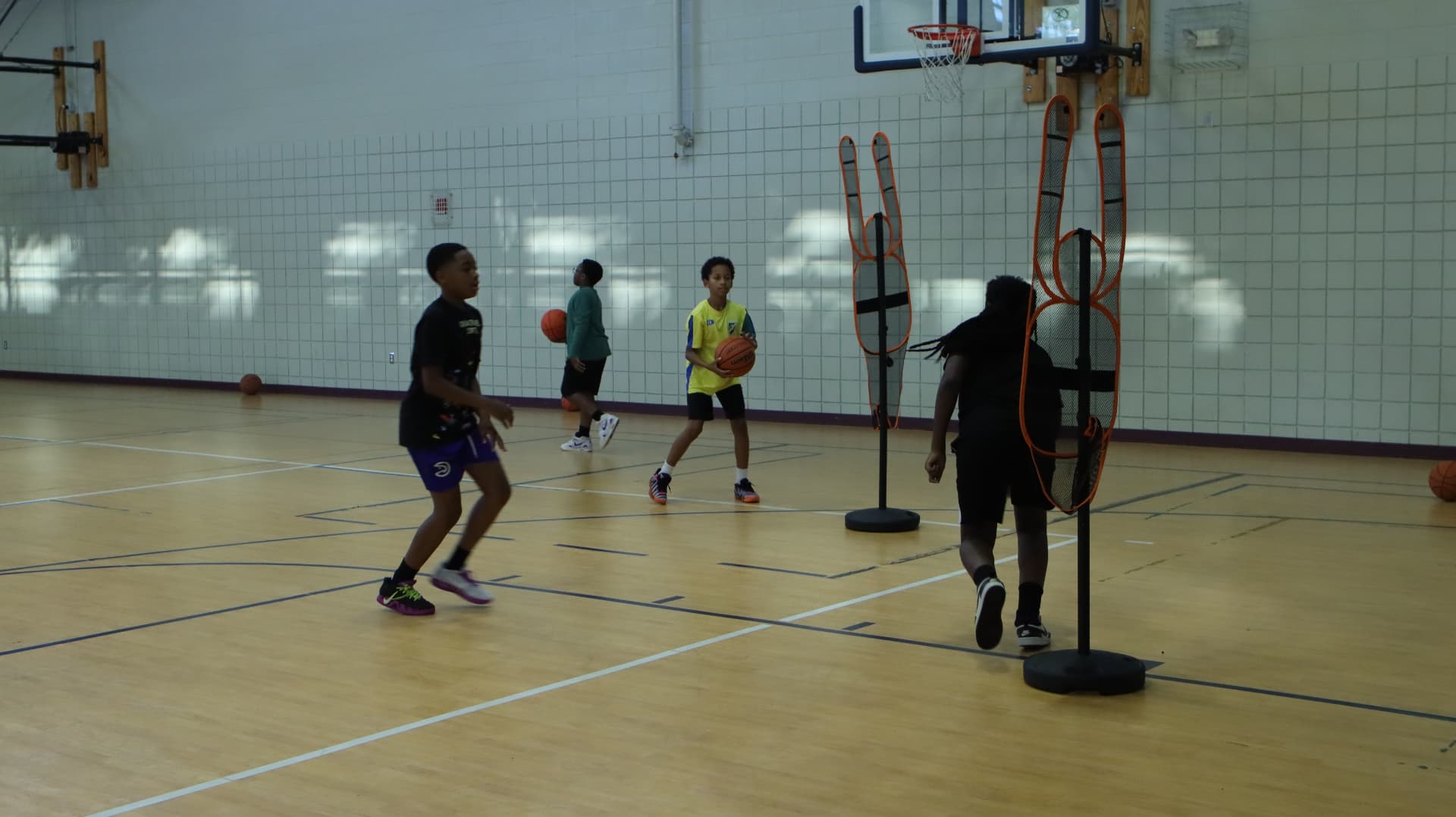 Advanced Fundamentals athlete driving past defenders in a yellow jersey